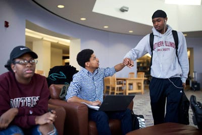 Rozzie Caribs (center) greets his friend Calvin Stewart during a “study jam” at the library at Southern Illinois University, Carbondale on April 10. Cribbs received a full-ride college scholarship through the Jordan Brand’s Wings program.