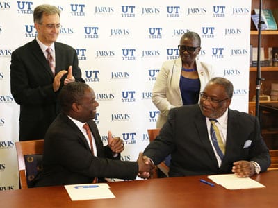 Jarvis Christian College President Dr. Lester C. Newman (right) and UT Tyler President Dr. Michael Tidwell shake hands after signing a memorandum of understanding.