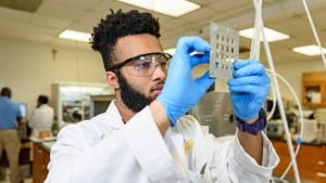 Male Xavier University student working in laboratory